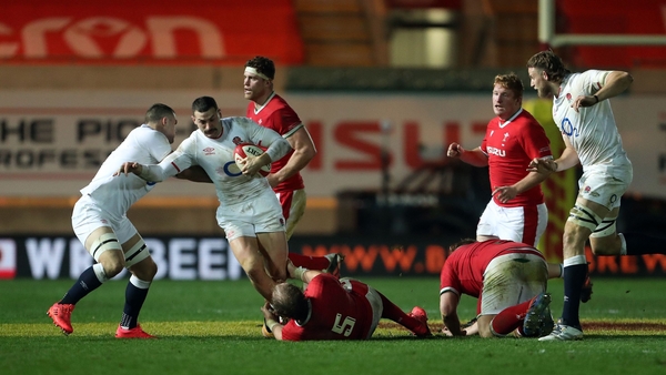 England's winger Jonny May is tackled by Welsh lock Alun Wyn Jones