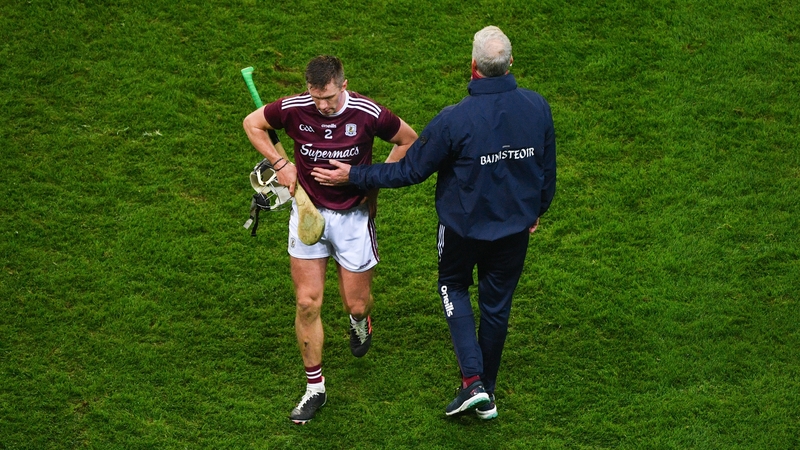 Galway manager Shane O'Neill consoles Aidan Harte after their team's loss to Limerick