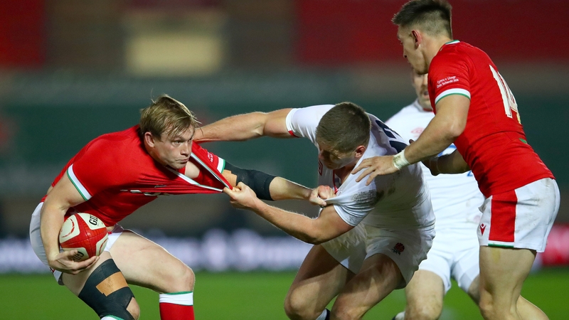 Nick Tompkins is tackled by Owen Farrell at Parc y Scarlets.