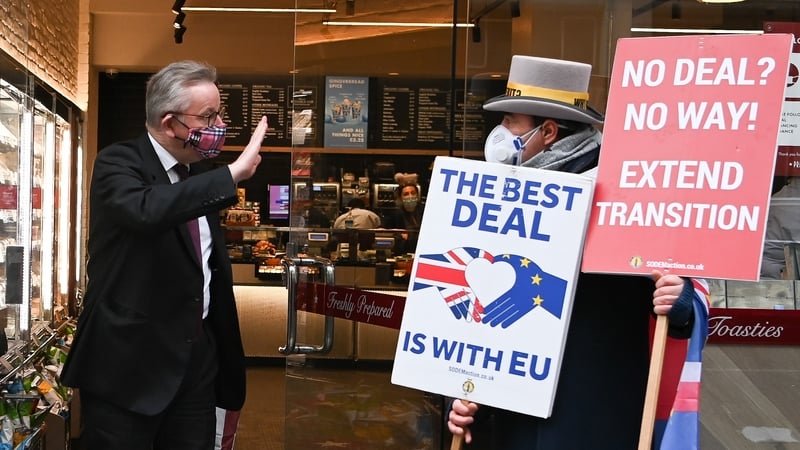 Michael Gove gestures as he passes anti-Brexit demonstrator Steve Bray in London