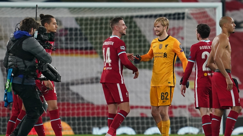 A beaming Caoimhin Kelleher celebrates Liverpool's win with captain Jordan Henderson