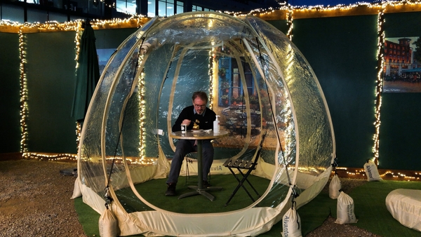 Tram Café co-owner Dave Fitzpatrick tests out a 'dining bubble'