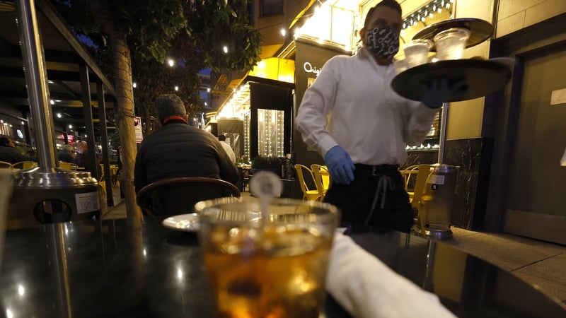 Waiter in San Francisco where bars and restaurants will no longer be permitted to serve outdoors