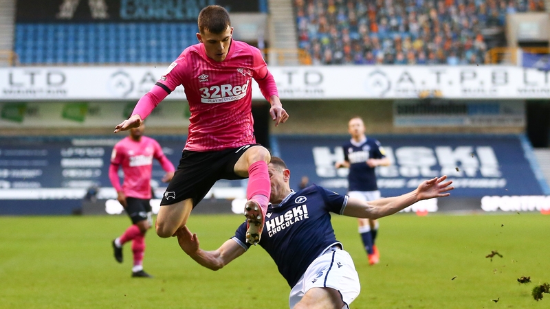 Murray Wallace of Millwall battling for possession with Jason Knight of Derby County and Ireland (l)
