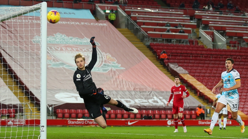 Caoimhin Kelleher tips a Wolves effort onto the post