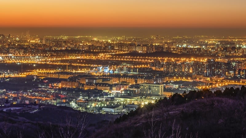 Buildings and lights seen from Xishan mountain in Beijing at dawn on 8 December