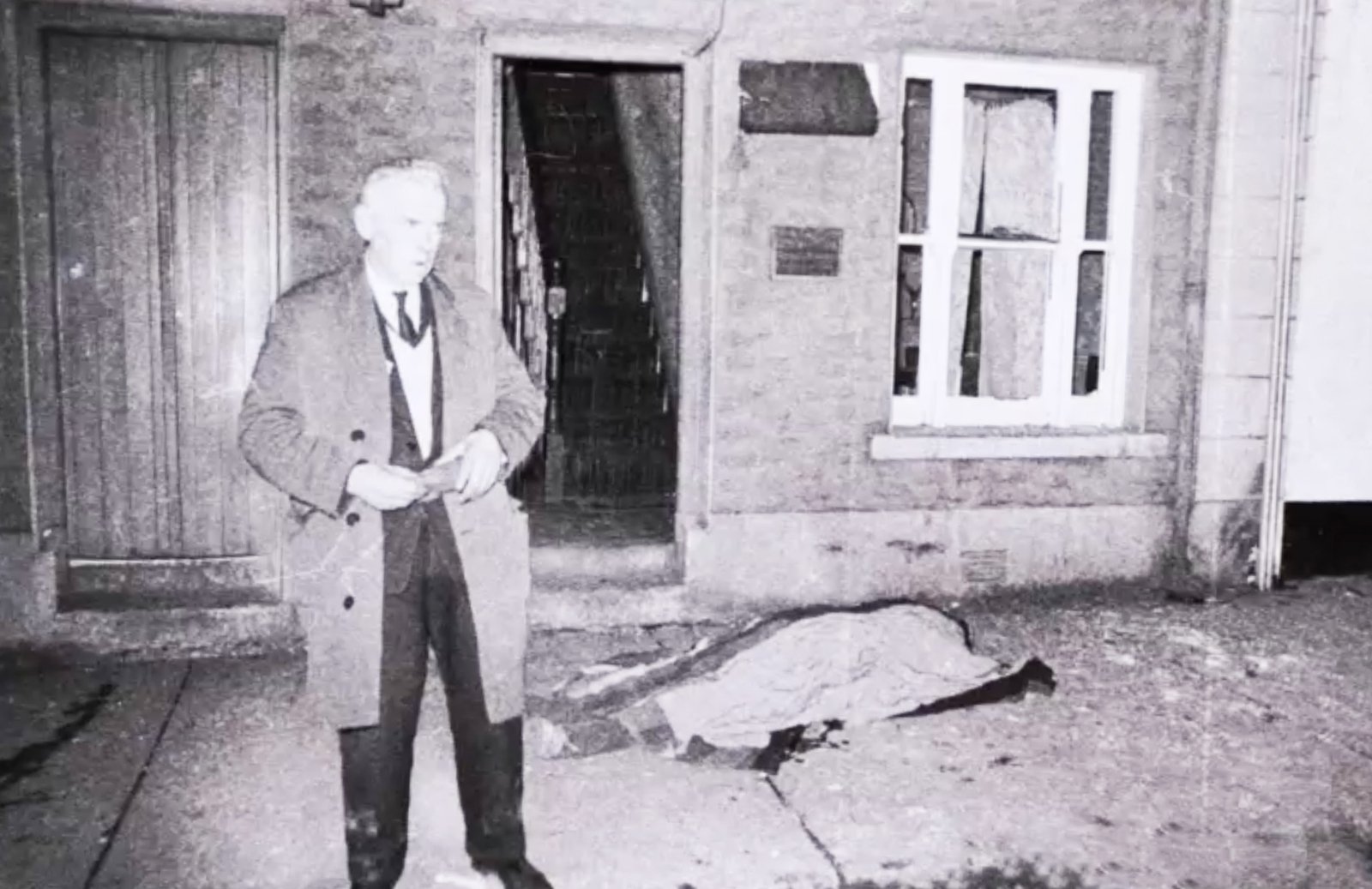Patrick Stanley lies dead on Main Street as a bystander looks on Photo: Paddy Ronaghan