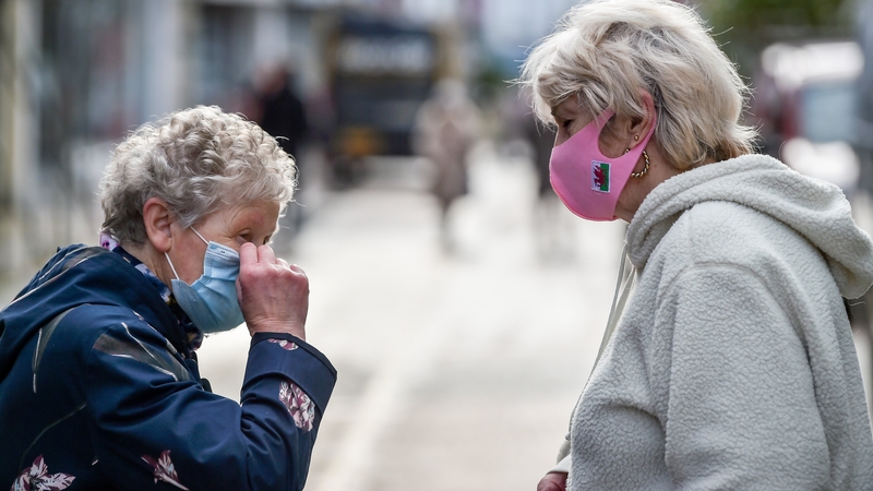 People chat on the High Street in Merthyr Tydfil, the area with the highest seven-day coronavirus case rate in Wales