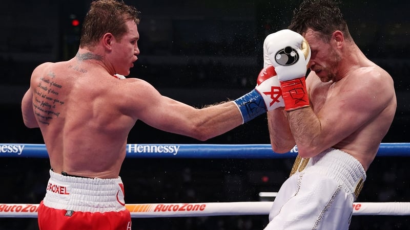 Canelo Alvarez (L) lands a punch on Callum Smith