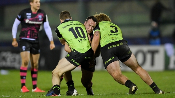 Bryan Byrne of Bristol Bears is tackled by Jack Carty, left, and Finlay Bealham