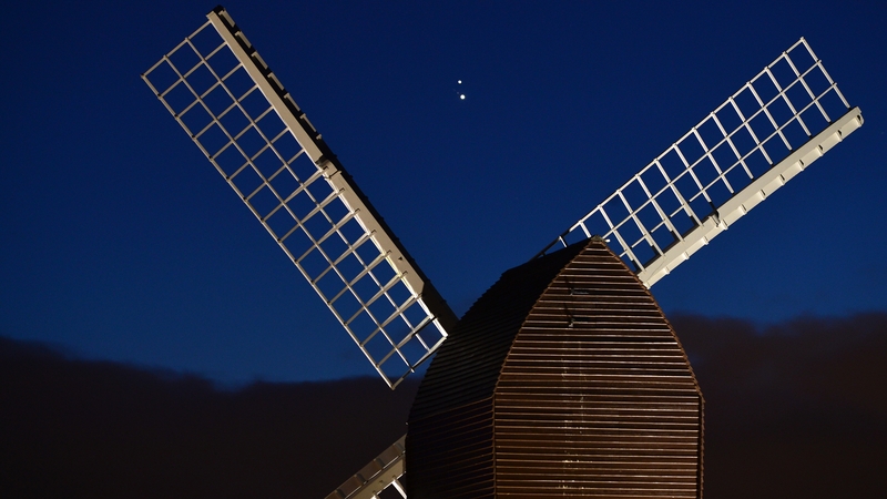 Jupiter and Saturn are seen coming together in the night sky over Brill windmill in England