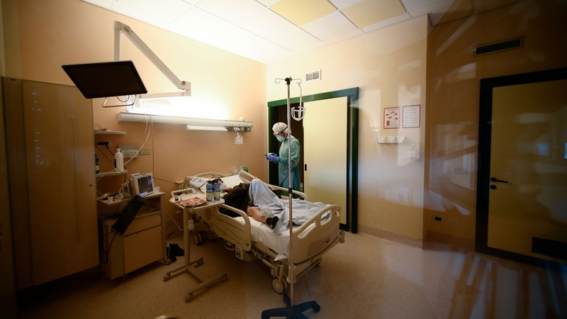 A medical worker tends to a patient in the Tor Vergata hospital in Rome on December 21, 2020, during the Covid-19 pandemic caused by the novel coronavirus