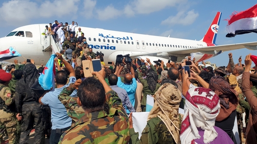 Crowds who had gathered on the airport apron waiting to greet the new government fled, terrified
