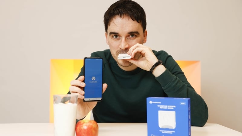 Aonghus Shortt with FoodMarble's AIRE device and app.