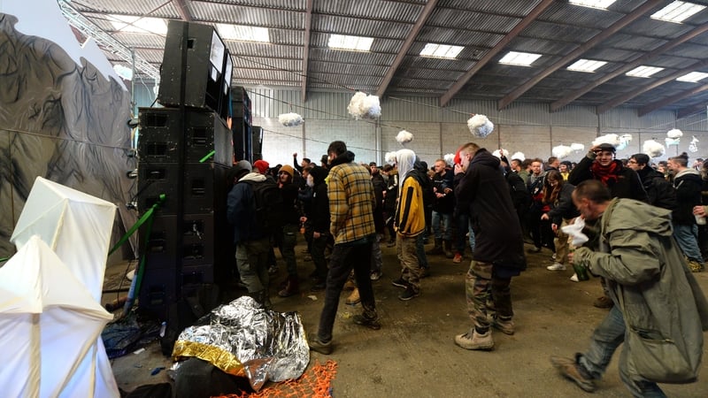 Party-goers dancing at the rave in a disused warehouse in Lieuron, Brittany, France