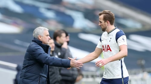 Mourinho shakes hands with Harry Kane as he leaves the pitch