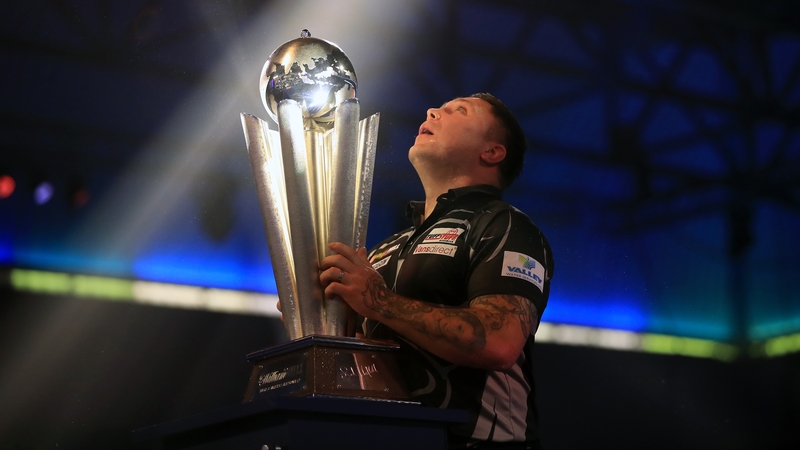 Gerwyn Price lifts the Sid Waddell trophy after winning the World Championship at Alexandra Palace