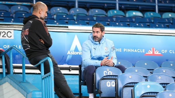 Pep Guardiola, manager of Manchester City speaks with goalkeeper Scott Carson