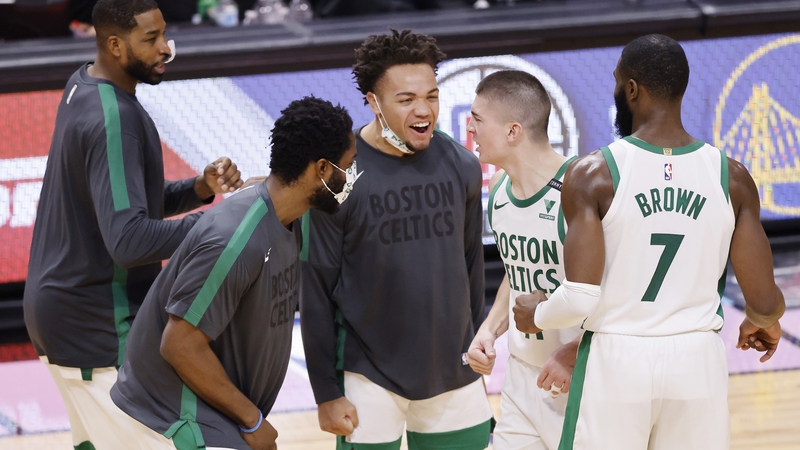 Payton Pritchard #11 of the Boston Celtics celebrates with his team-mates
