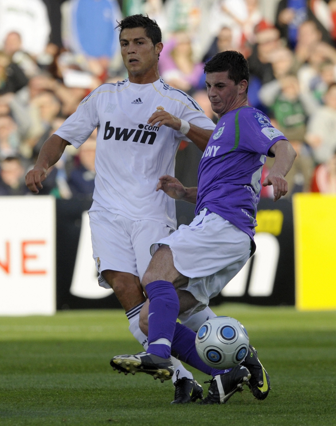 Cristiano Ronaldo vies with Padraig Amond during a 2009 friendly