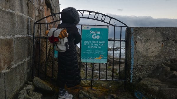 A swimmer watches the sea at the Forty Foot in Dublin during the lates Covid-19 Level 5 lockdown. Photo: Artur Widak/NurPhoto via Getty Images