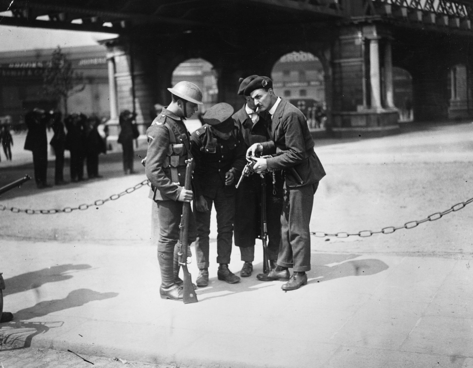 British soldiers watch a Black and Tan reload his revolver outside the Custom House. Photo: Walshe/Getty Images