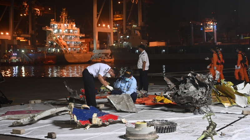 Officials from the National Transportation Safety Committee conducting identification of the wreckage