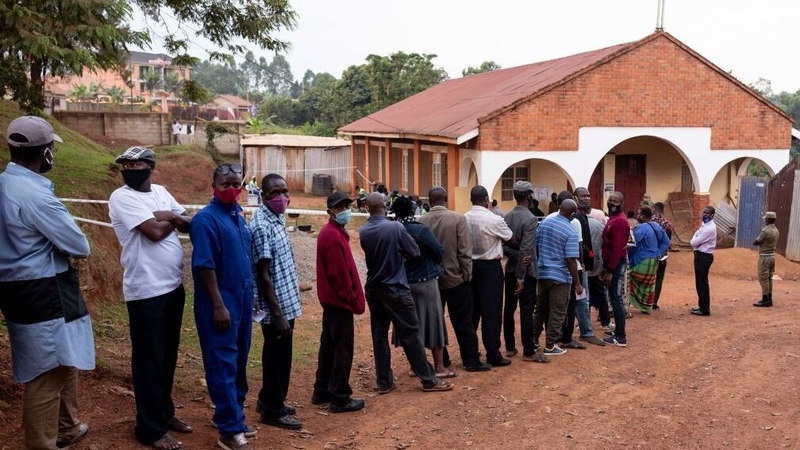 Voters queue outside a polling station in Kampala, Uganda