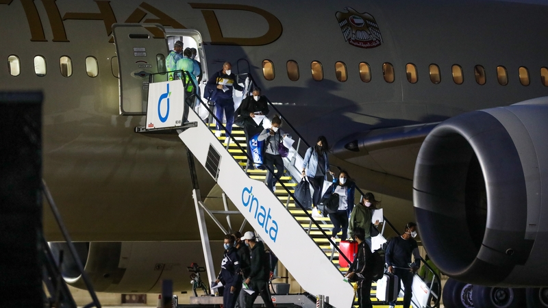 Tennis players and their support teams are seen disembarking Flight EY460