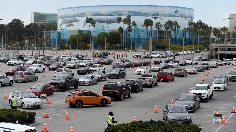 Hundreds of cars line up outside a mass vaccine site in Long Beach, California, today