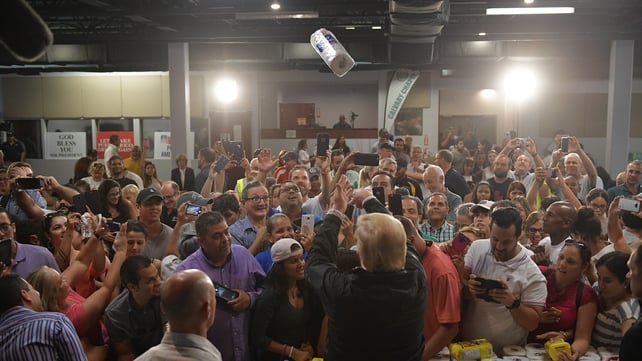 Criticised over his response to the devastation caused in Puerto Rico by Hurricane Maria, Trump throws paper towels to people during a brief visit there in 2017