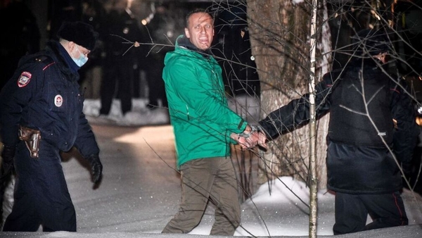 Alexei Navalny being escorted out of a police station in Khimki, outside Moscow, on Monday