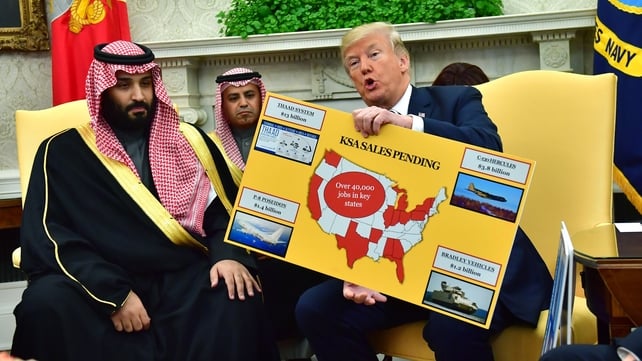 Donald Trump holds up a chart of military hardware sales as he meets Saudi Arabia's Crown Prince Mohammed bin Salman in the Oval Office in 2018