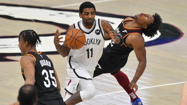 Kyrie Irving of the Brooklyn Nets runs into Cleveland's Collin Sexton
