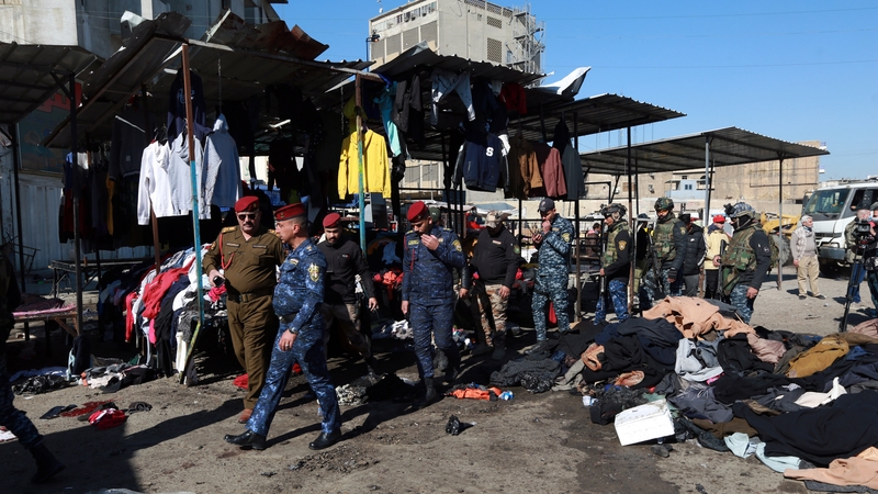 Officials inspect the explosion site at al-Tayaran Square