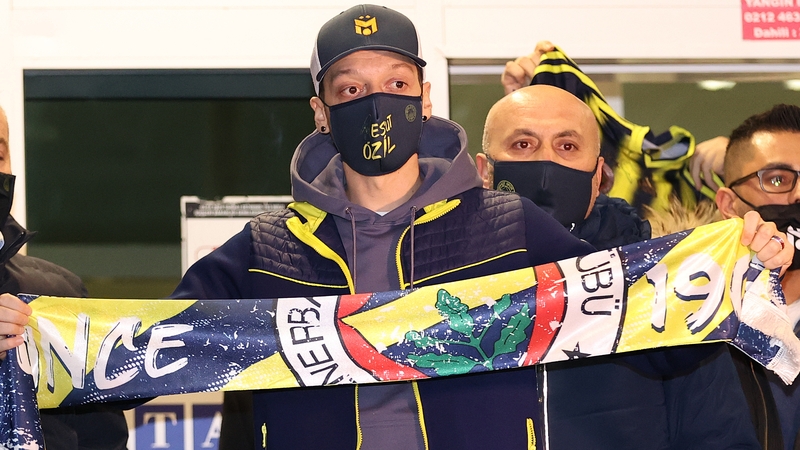 Mesut Ozil holds up a Fenerbahce scarf in Istanbul