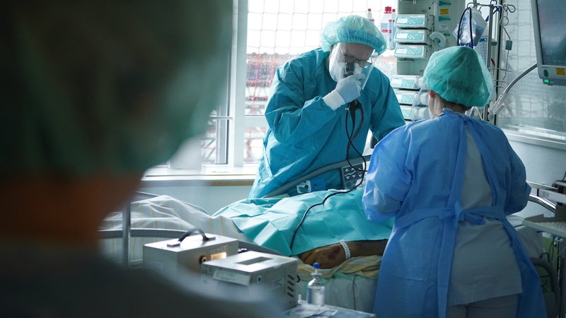A doctor examines the lungs of a Covid patient via a bronchoscopy in the Covid intensive care unit at Leipzig university hospital