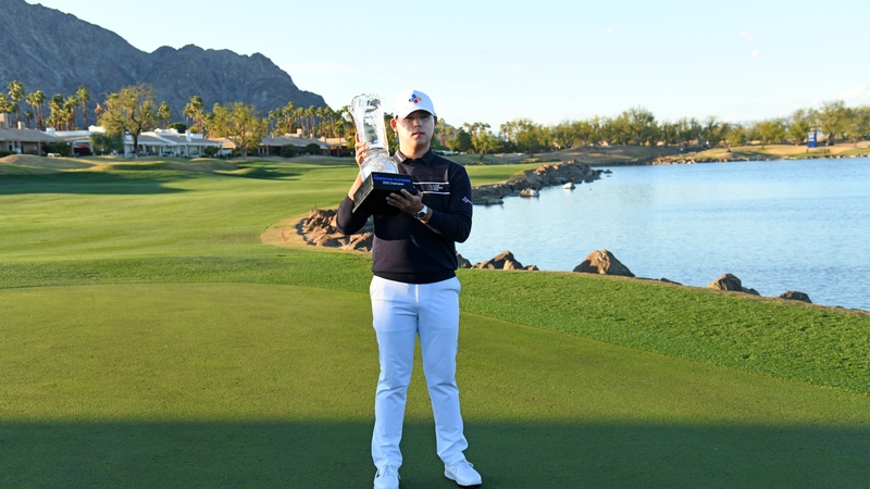 Si Woo Kim of South Korea with the trophy following his victory in California