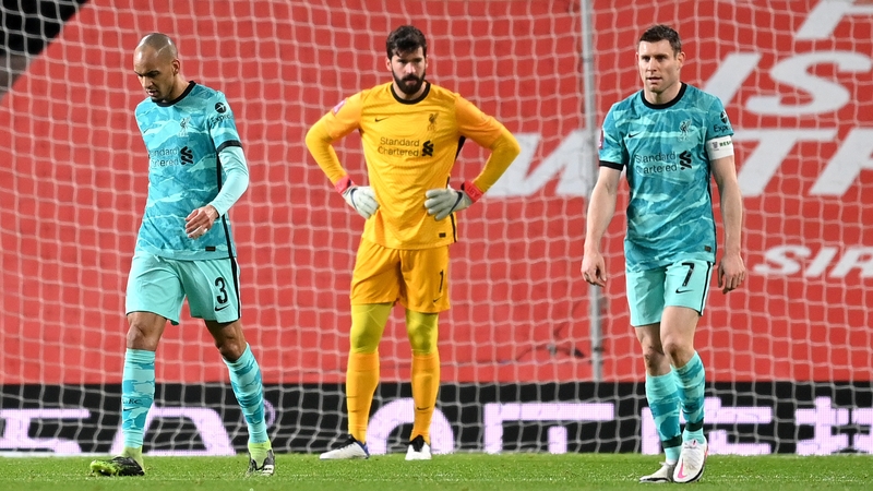 James Milner, Fabinho and Alisson Becker look dejected after Manchester United's first goal