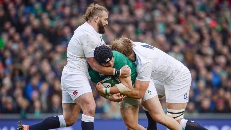 Robbie Henshaw tackled by Joe Marler, left, and Joe Launchbury in 2017