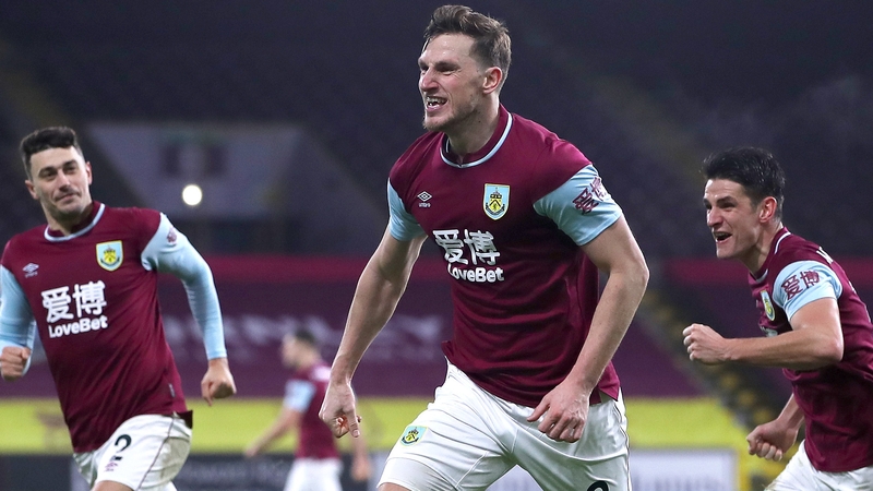 Chris Wood of Burnley celebrates with team mates (L - R) Matthew Lowton and Ashley Westwood