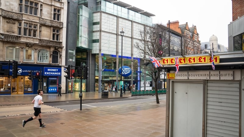 A jogger runs along an empty Oxford Street in London during England's third national lockdown