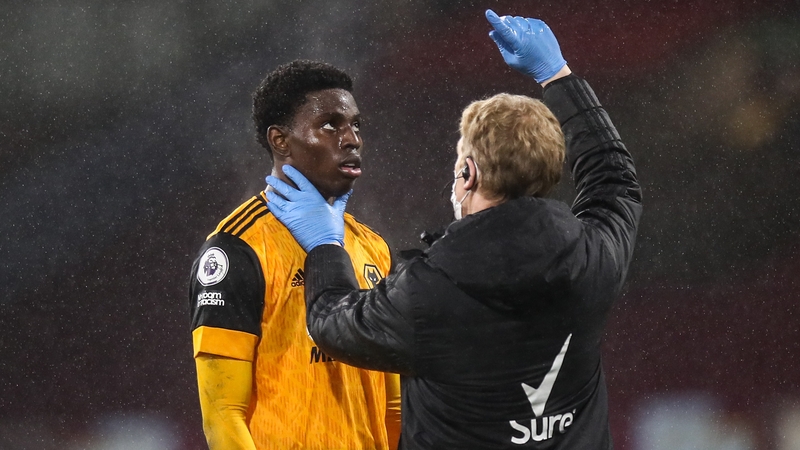 Owen Otasowie of Wolves is assessed for a possible concussion