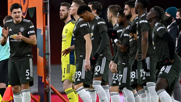 Manchester United captain Harry Maguire encourages his team-mates before the draw with Arsenal