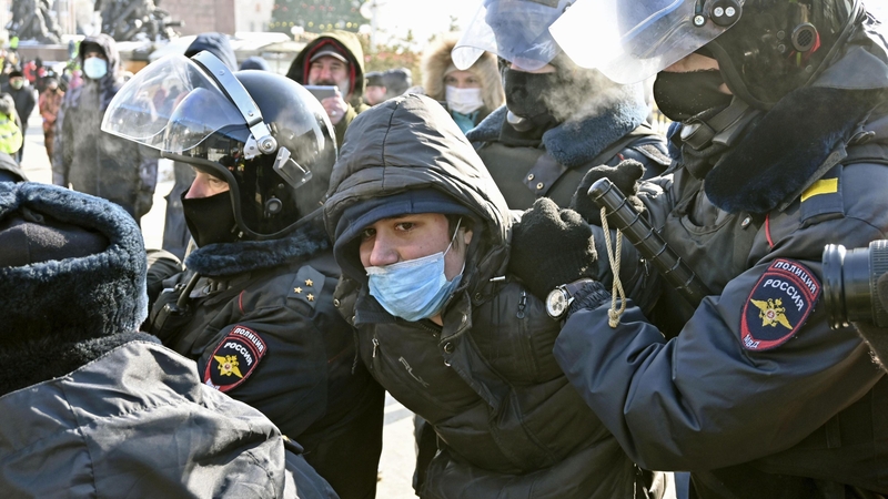 A man is detained by police at a protest in Vladivostok
