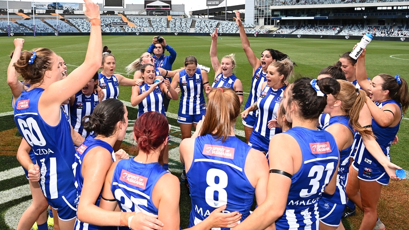 Aileen Gilroy (8) celebrates with her North Melbourne team-mates after the opening-round victory