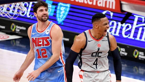 Russell Westbrook celebrates in front of Joe Harris of the Brooklyn Nets after making the game-winning shot