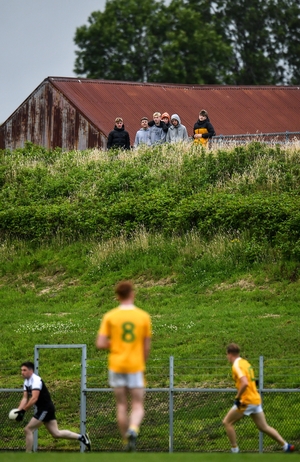 You can close the gates but it won't stop them watching. Young spectators locate a useful vantage point to follow the play between Clonduff and Kilcoo at Clonduff Park in Newry.