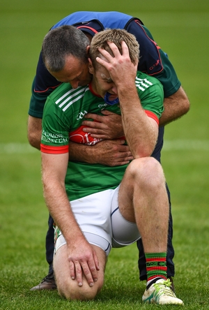 Say it ain't so. Noel McGrath, being comforted by his team manager and uncle Frankie McGrath, endures the anguish of losing a county final in the last minute for the second time in seven days.
