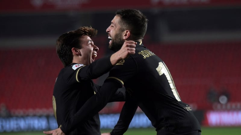 Jordi Alba (R) celebrates with Riqui Puig (L) after scoring Barcelona's fifth goal against Granada
